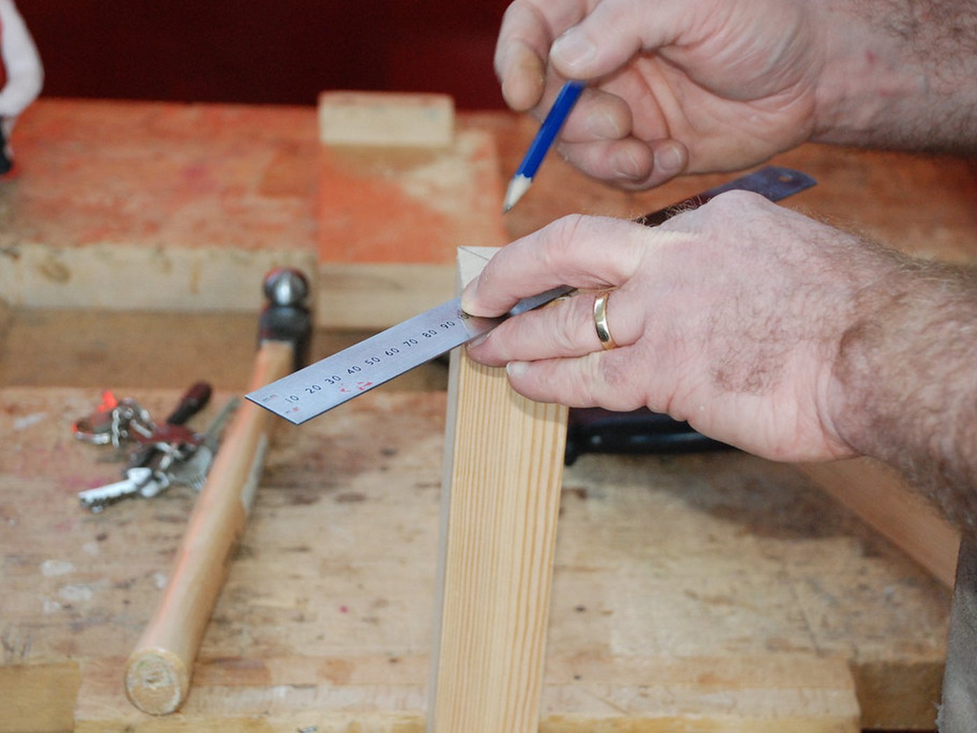 Hands stringing a freshly built acoustic guitar